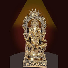 Brass Ganesha murti with ornate arch halo, seated figure on engraved base