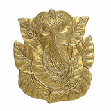 Brass Ganesha wall hanging with pipal leaf halo, ornate jewelry and crown