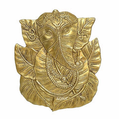 Brass Ganesha wall hanging with pipal leaf halo, ornate jewelry and crown