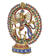 Brass Natraj dancing idol with red-blue stonework halo and jeweled base