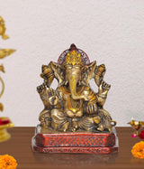 Brass Lord Ganesha idol statue with raised arms, detailed gold and red base, 7 inch