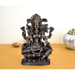 Resin Lakshmi idol statue, seated with ornate crown and purple accent details