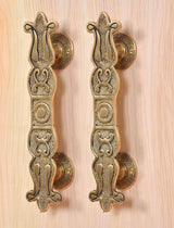 Golden brass main door handle pair with embossed floral scroll pattern
