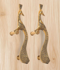 Golden brass peacock door handle pair, arched tail shape and textured surface