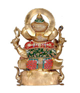 Back view: brass Ganpati statue with circular halo and red-green embroidered lower cloth
