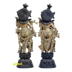 Brass Radha Krishna sculpture seen from back, circular ornaments on pedestal