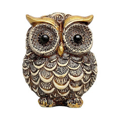 Polyresin owl statue in white with gold accents, detailed feather pattern and eyes.