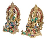 Brass Lakshmi and Ganesh idols in angled front views, colorful jewel borders and crowns