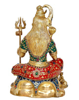 Back view brass Shiva sculpture, trident in hand, red and green jeweled robe