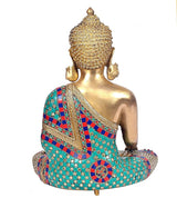 Back view brass Buddha statue, seated earth-touching pose, teal red patterned robe