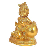 Brass laddu Gopal statue holding round laddu, engraved base, gold finish.