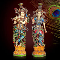Resin Radha-Krishna figurines, ornate multicolored designs, standing on decorative bases