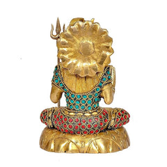 Rear view of brass Shiva idol with trident, turquoise necklace and red gemstone robe