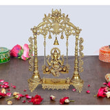 Brass Ganesha swing with ornate frame and three hanging bells, 26 in height