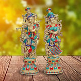 Brass Radha-Krishna idol, two standing figures with teal, red, and gold details