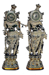 Back view of black brass Radha Krishna idol pair with circular halo ornament