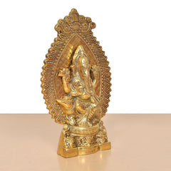 Gold metal Ganesha idol, angled view, intricate carvings on the base