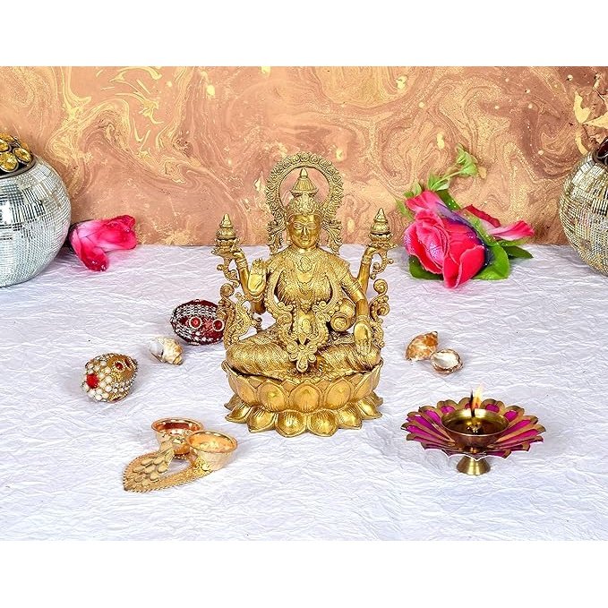 Brass Lakshmi Maa statue with raised hands, seated on a lotus base