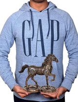 Mechanical horse resin statue held in front of a blue GAP hoodie, 9 in tall