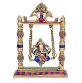 Gold brass Ganesha swing idol, seated on colorful blue base under hanging chains