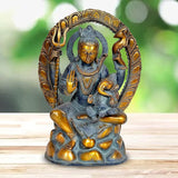 Shiva sculpture in dark blue with gold face, halo, and raised hands, seated