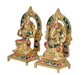 Lakshmi and Ganesha statue figurines, angled view with ornate gold halo arches
