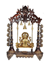 Brass Ganesha swing with dark metal arch, gold figure, hanging bell chains, brown base