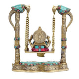 Brass Ganesha swing statue back view with carved circular halo and jeweled chains