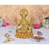 Brass Lakshmi idol seated with four arms, ornate crown halo and lotus base