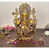 Brass Ganesha idol, ornate crown and four arms, seated; 16-inch height