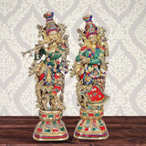 Brass Radha Krishna sculpture: ornate two-deity figures, multicolor attire, 29 in
