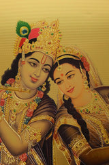 Close-up of Radha and Krishna with jeweled crowns on a goldfoil wall poster