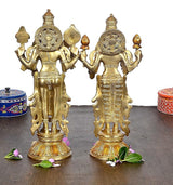 Gold-tone Vishnu and Lakshmi idol statue, side view with multi-armed design