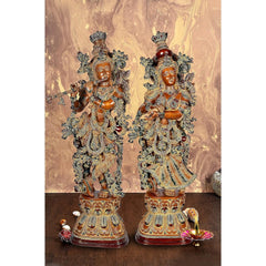 Brass Radha Krishna figurine, two standing poses on ornate pedestal, brown