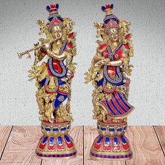 Radha-Krishna brass Murti pair: two statues front view, gold with blue-red detailing