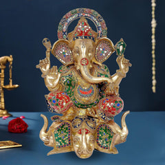 Brass Ganpati murti with multicolor temple detailing, seated on lotus, raised hands