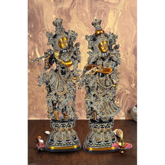 Black brass Radha Krishna idol, two standing figures with ornate crowns and jewelry