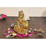 Brass Bal Krishna statue, seated Gopal holding laddu; 7.5 in height, gold finish.
