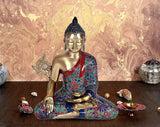 Buddha statue with brass face, seated cross-legged in Bhumisparsha pose, patterned robe