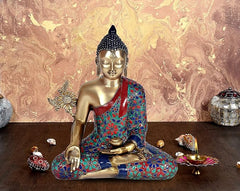Buddha statue with brass face, seated cross-legged in Bhumisparsha pose, patterned robe
