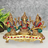 Brass Lakshmi Ganesh Saraswati statue: three seated deities, red/blue jewels, 6.5 in