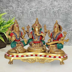 Brass Lakshmi Ganesh Saraswati statue: three seated deities, red/blue jewels, 6.5 in