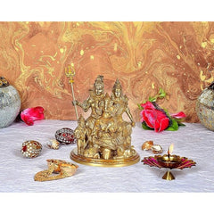 Brass Shiv Parivar family idol (10 in), seated figures with trident