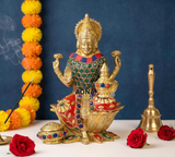 Brass Lakshmi idol with jeweled green dress and red skirt, seated on lotus base