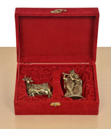 Open red velvet gift box with brass cow calf and Radha Krishna statues
