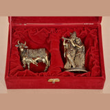 Brass Radha Krishna and cow calf figurines in open red velvet gift box