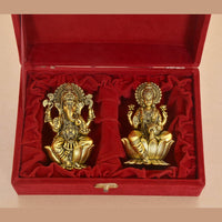 Golden brass Ganesh idol with ornate detailing in velvet presentation box