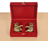 Red velvet gift box with two brass elephants, ornate patterned bodies