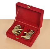 Open red velvet gift box with two brass elephant figurines