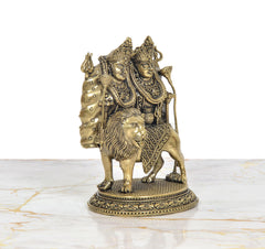 Brass Chamunda idol with lion in front and two deities behind, side angle